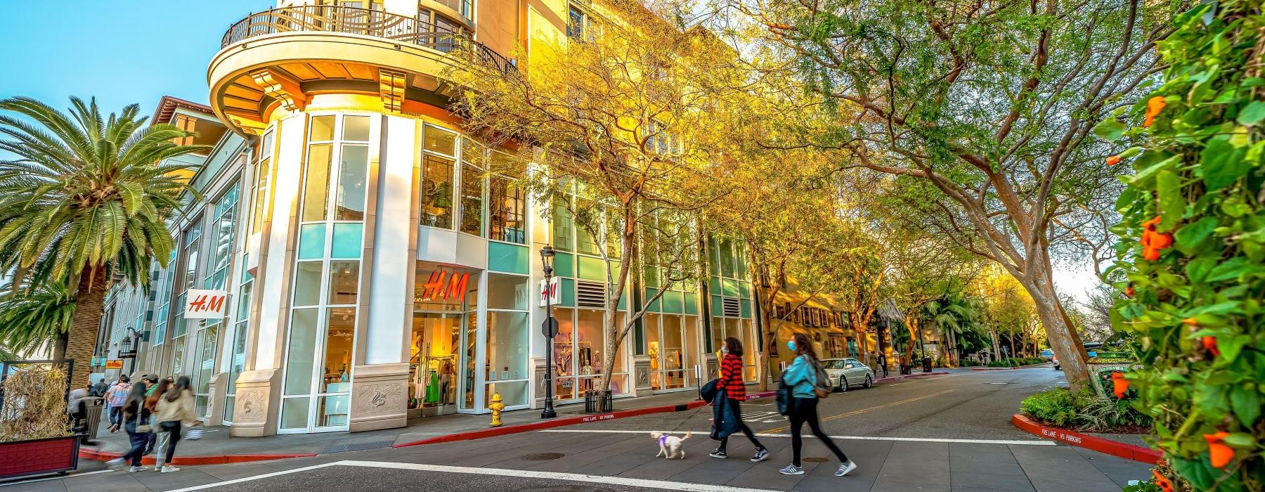 a building with trees and people walking around